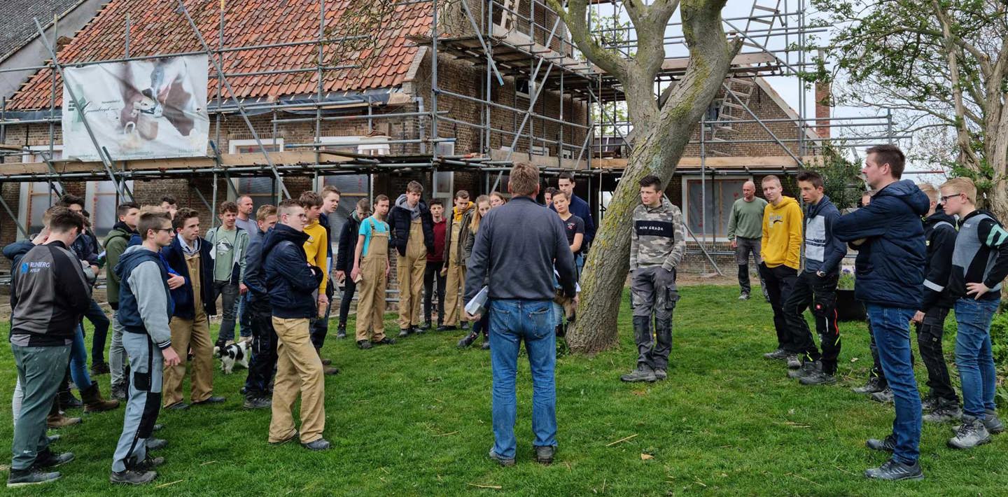 Leerlingen van het Calvijncollege in Krabbedijke worden rondgeleid op een restauratiebouwplaats.