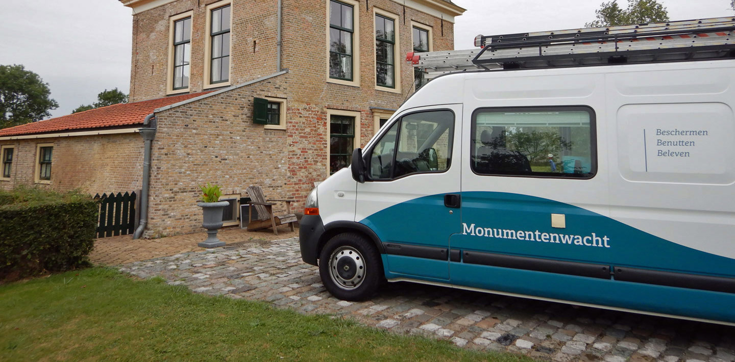 De inspectiebus van de Monumentenwacht bij een monumentaal pand.