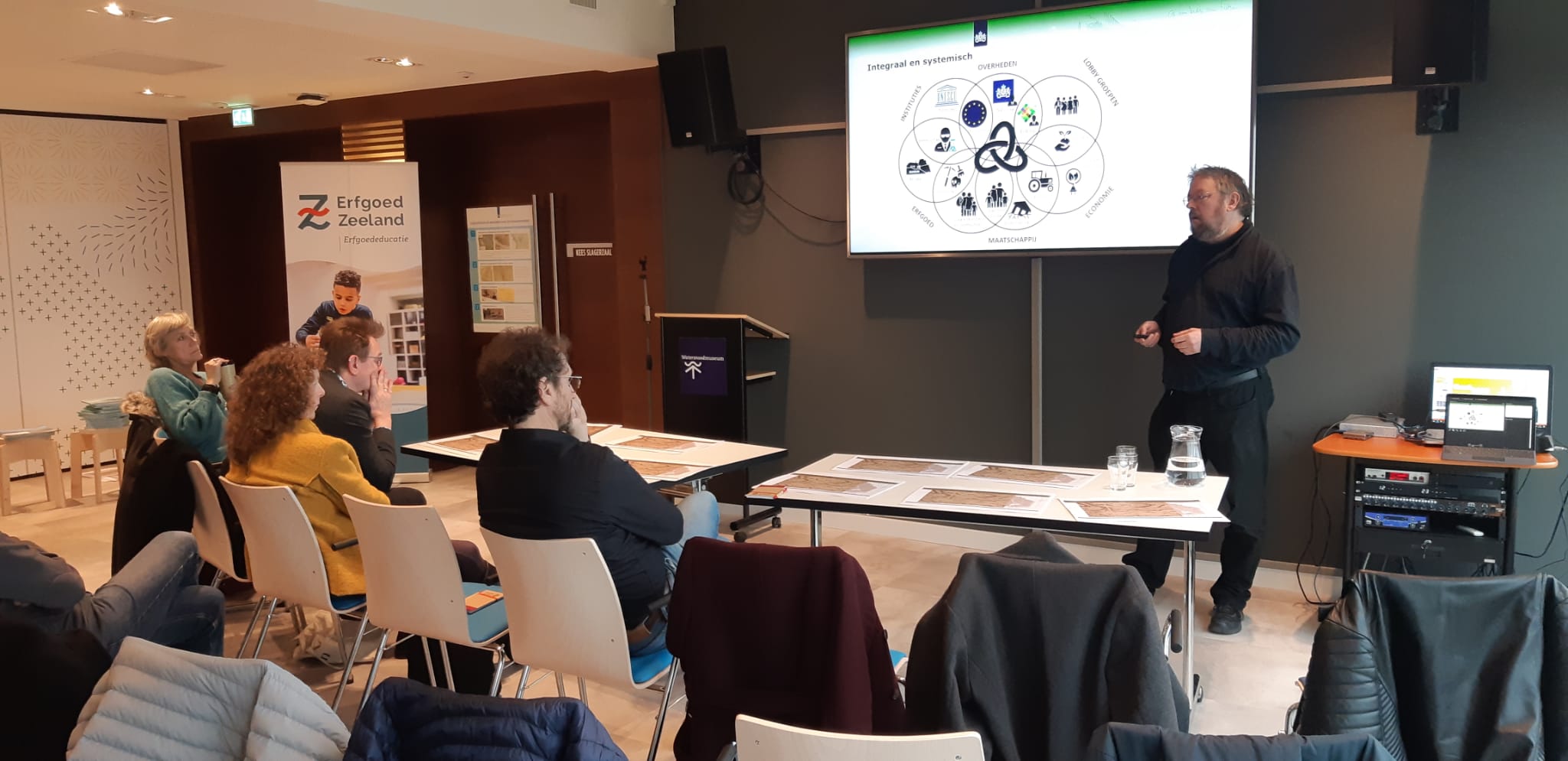 O.l.v. Menne Kosian (RCE) in de workshop 'Kennis uit het verleden' historische kaarten van Sint Philipsland onderzoeken.