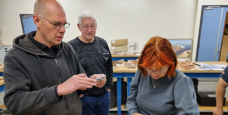 Onderzoekers bestuderen strandvondsten van het project Beach Archaeology in het archeologisch depot.